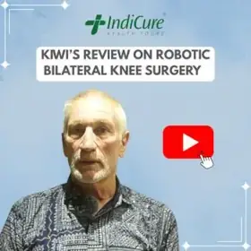 The image is a photograph of a Kiwi man named Neil promoting his review of robotic bilateral knee surgery with IndiCure.